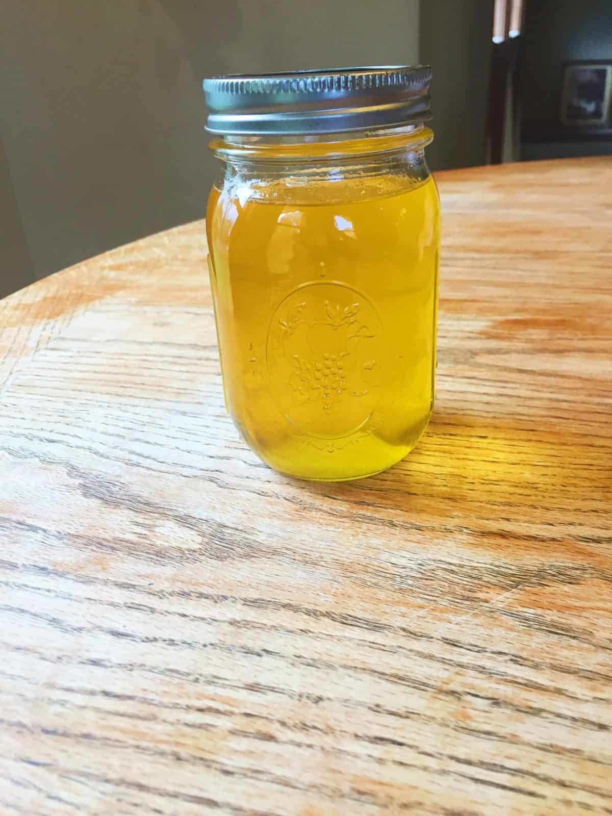 Ghee in a mason jar on a table.