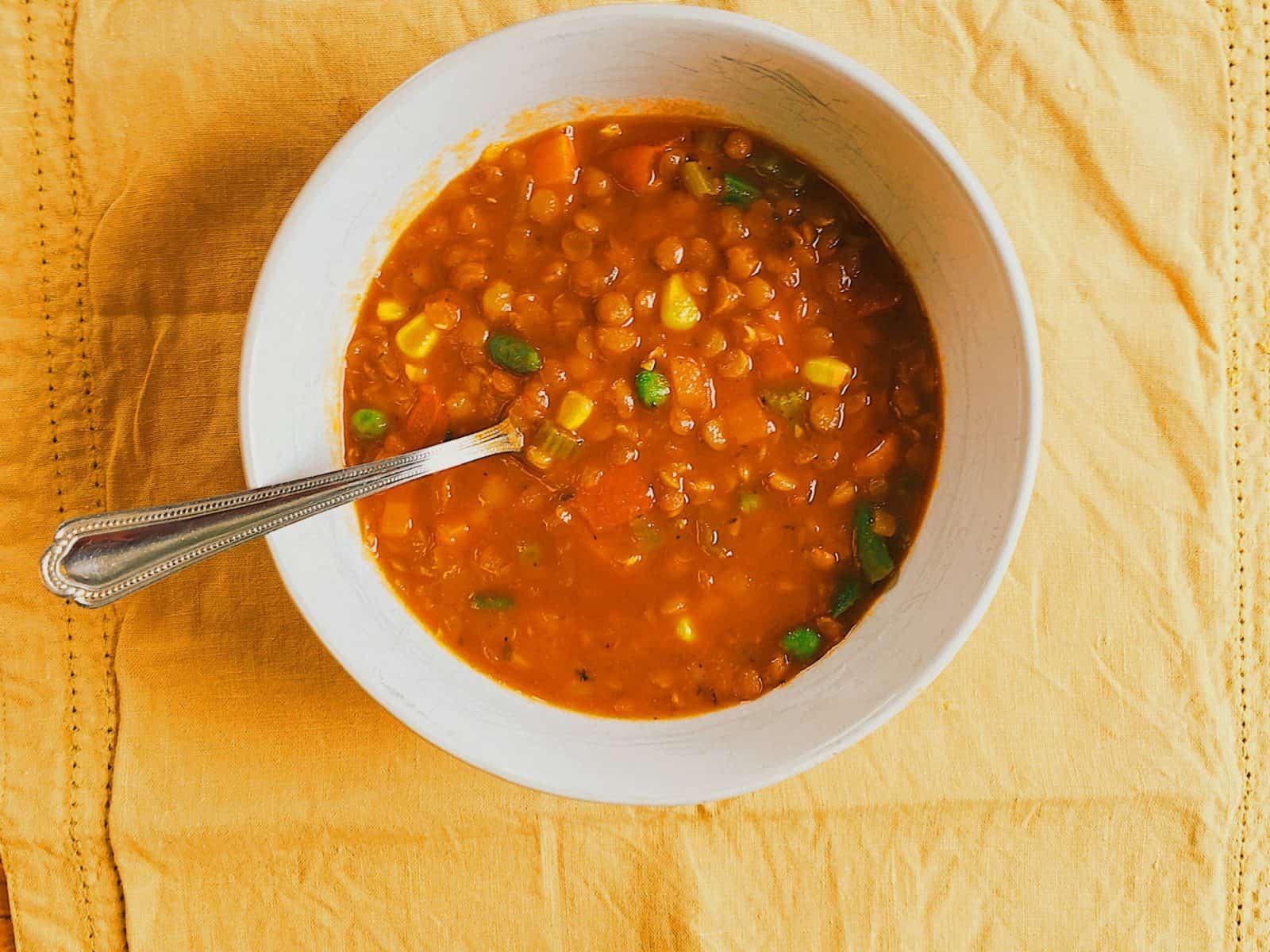 Overhead view of lentil soup in a bowl.