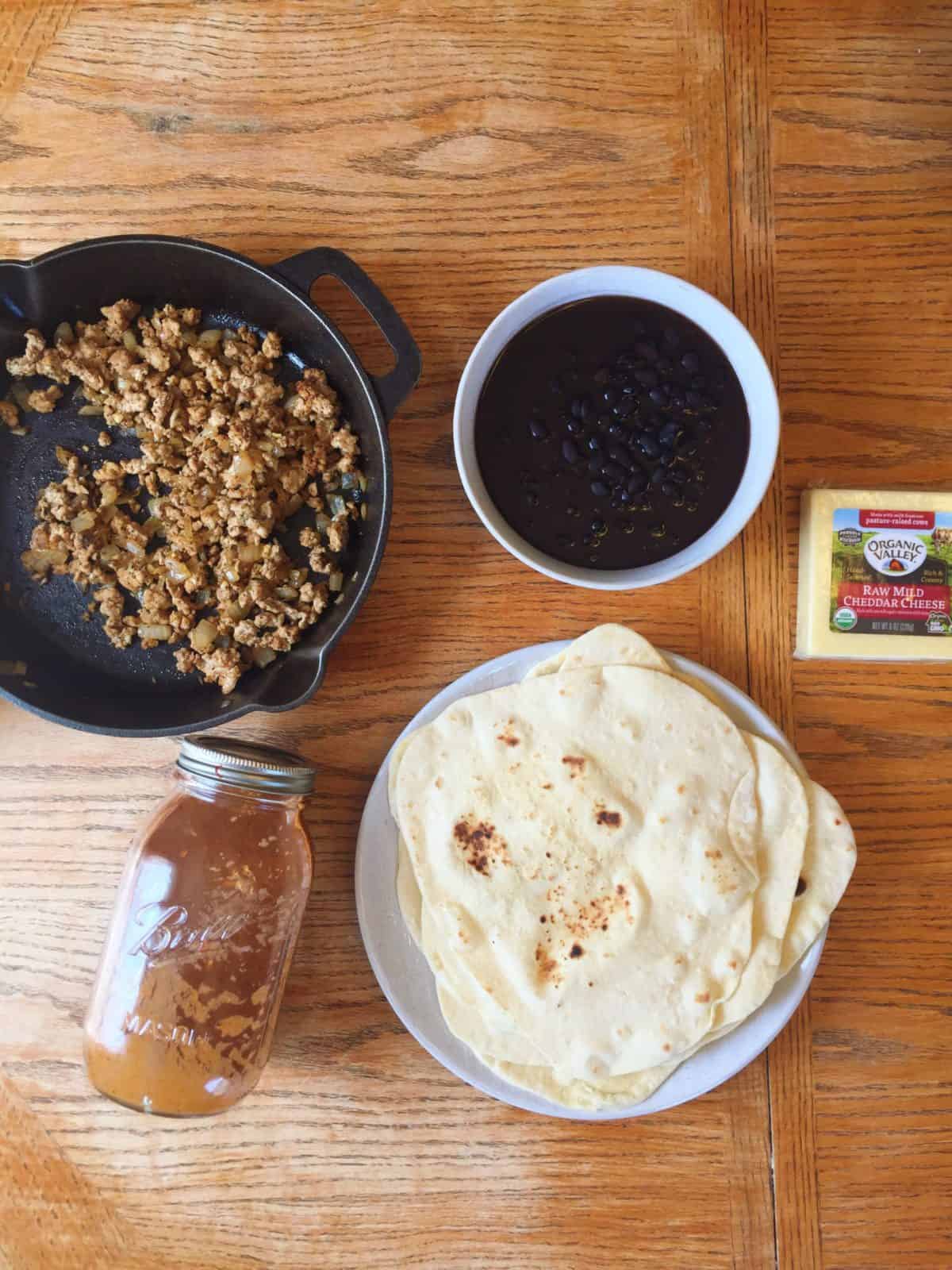 Enchiladas ingredients on a table.