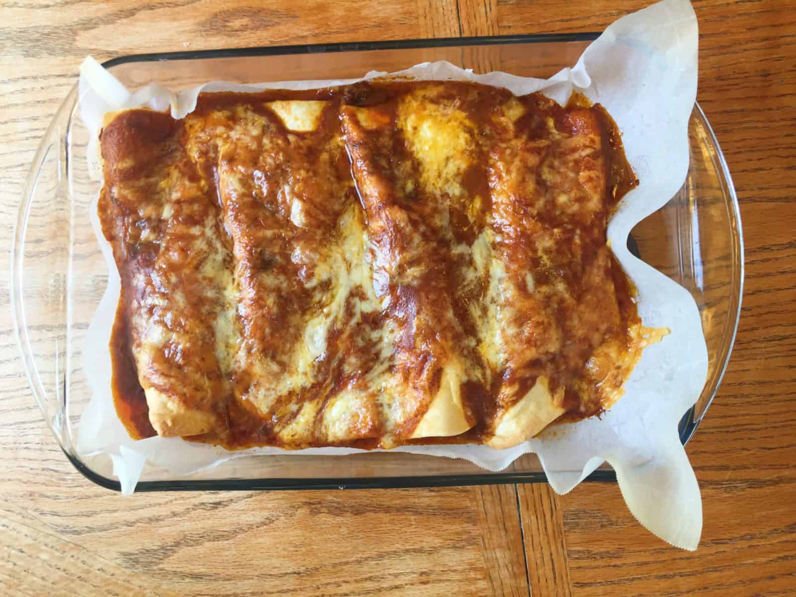 Baked enchiladas in a baking pan.