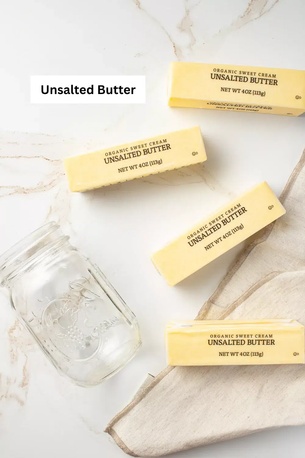 Sticks of butter on a counter with a jar. Instant Pot ghee ingredient infographic.
