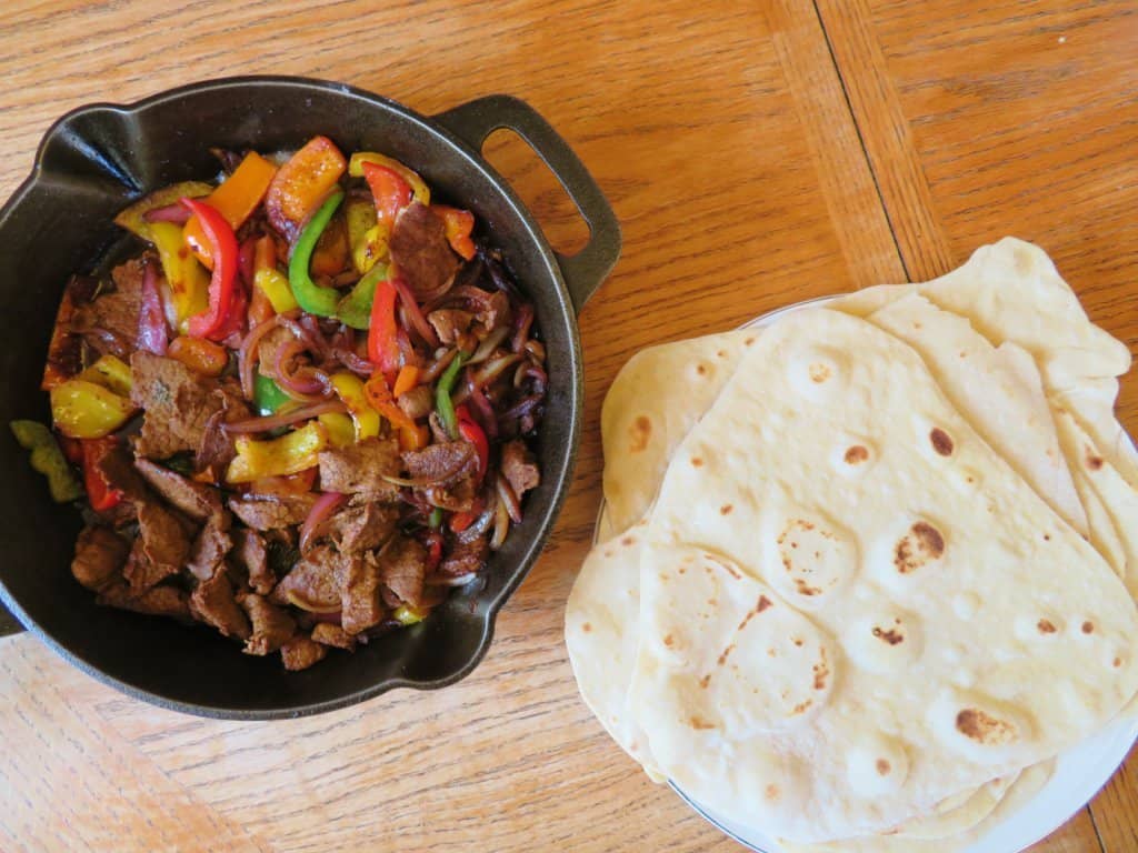 Beef Skillet Fajitas and flour tortillas on a table