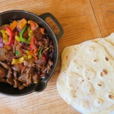 Beef Skillet Fajitas and flour tortillas on a table