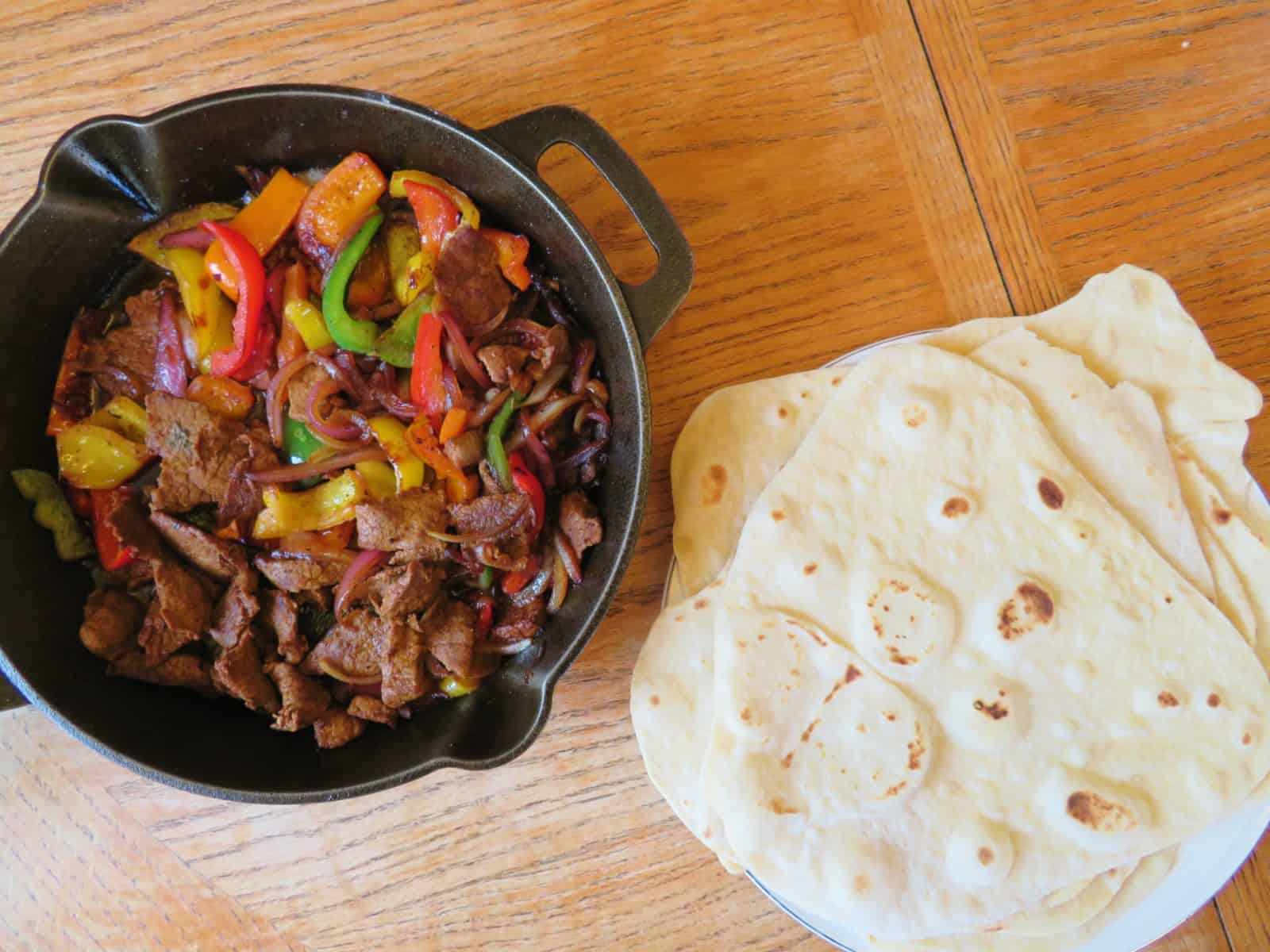 Beef Skillet Fajitas and flour tortillas on a table