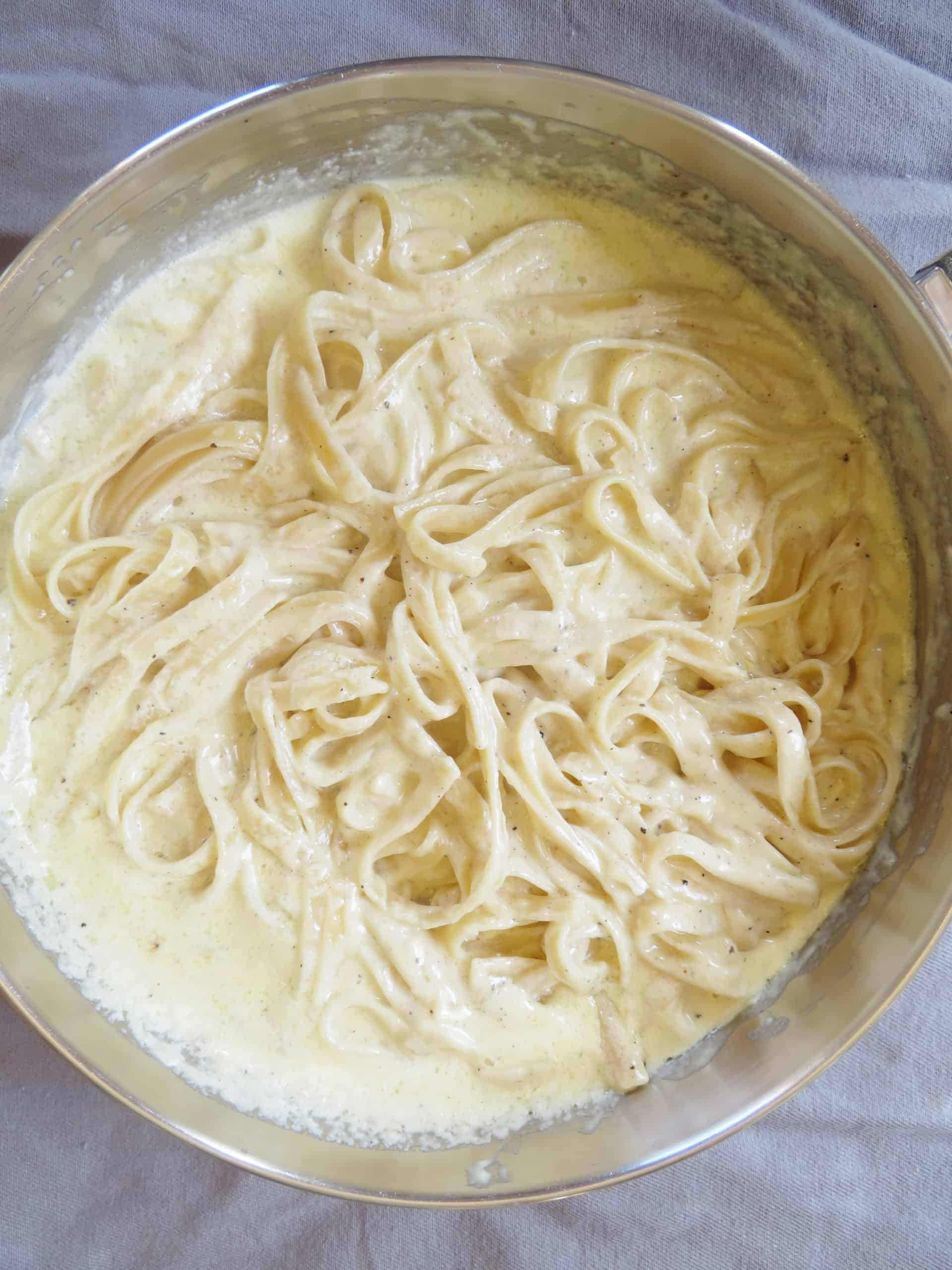 Fettuccine Alfredo in a skillet.