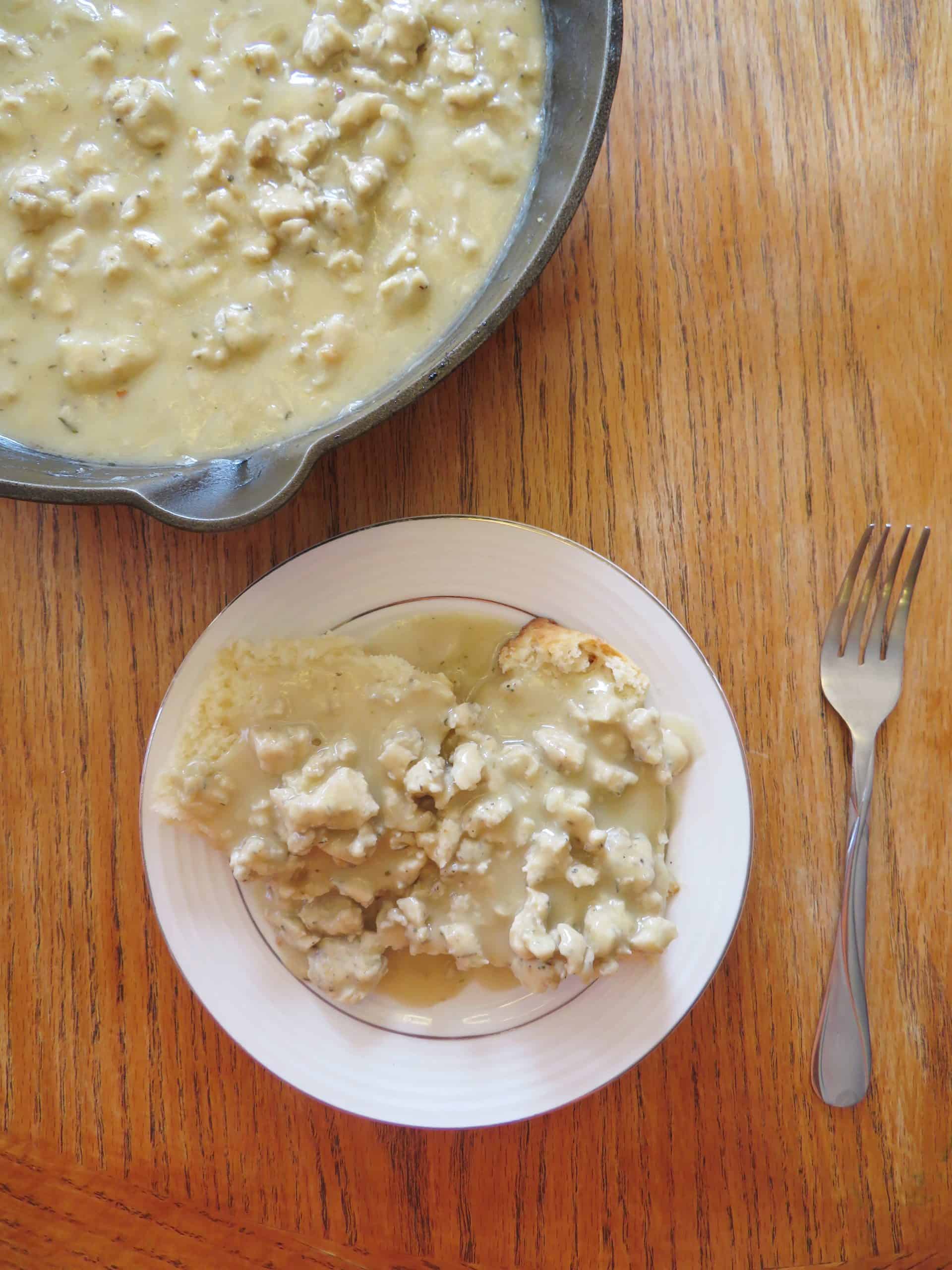 Overhead image of chicken sausage and gravy over biscuits.