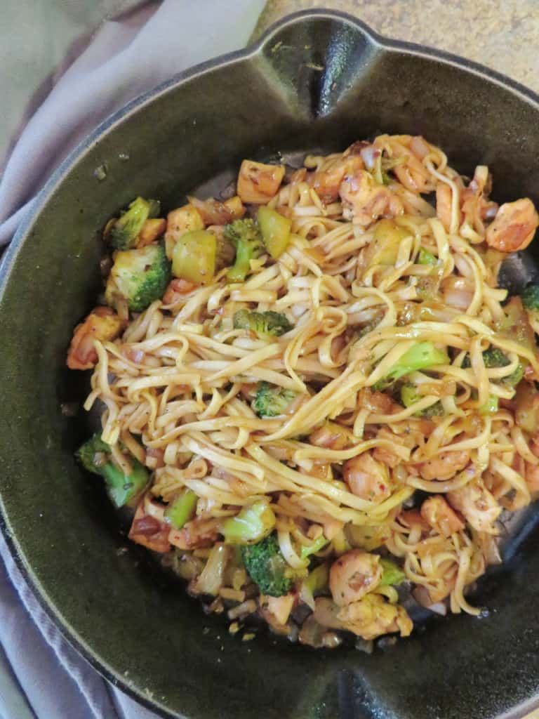 Chicken broccoli stir fry in a cast iron skillet.