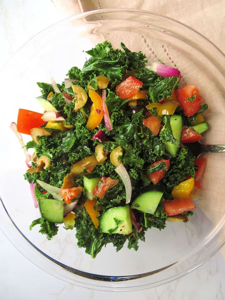 Close up of a finished kale salad in a bowl.