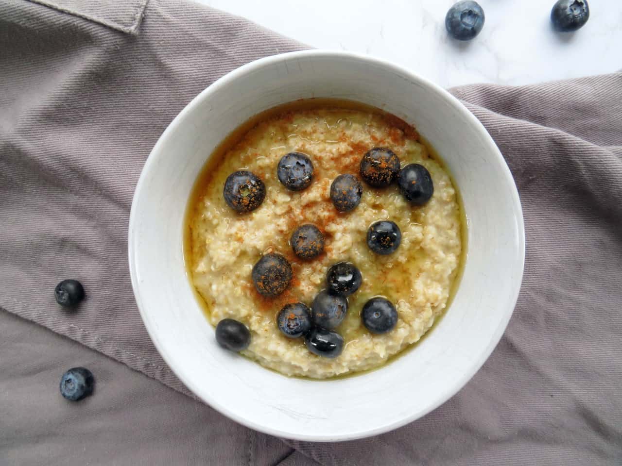 steel cut oatmeal with blueberries on a table.