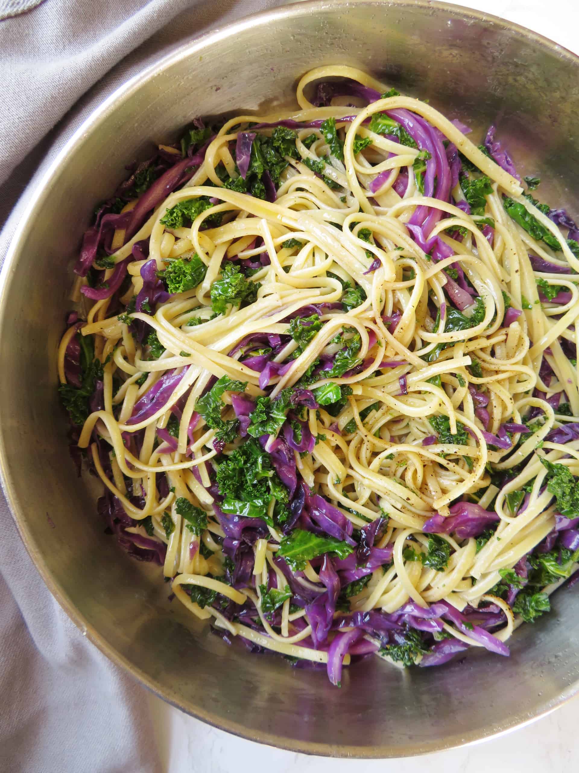 Close up on kale cabbage pasta in a skillet.