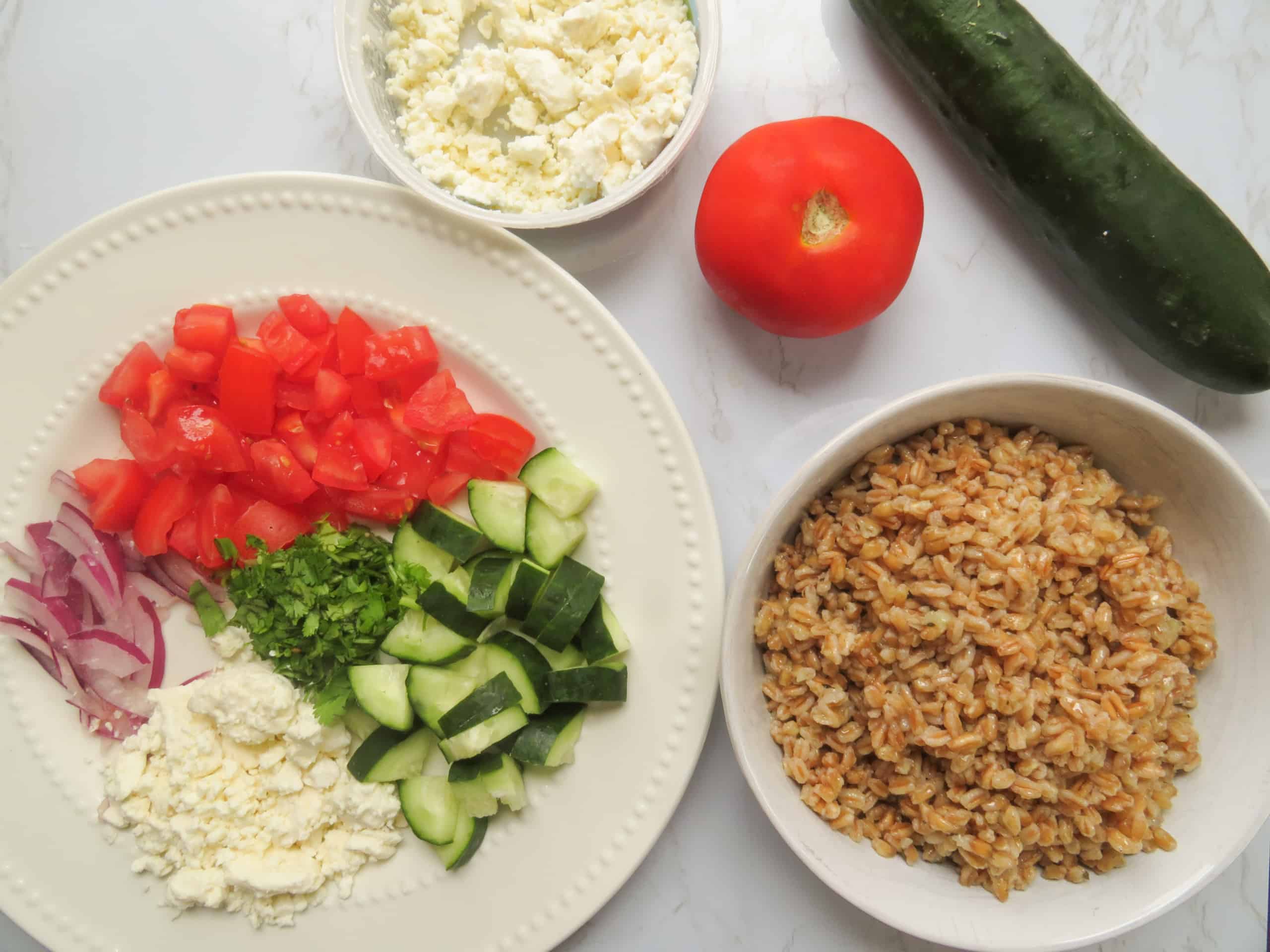 Farro salad ingredients on a counter.