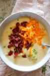 top view of potato soup in a bowl on a table