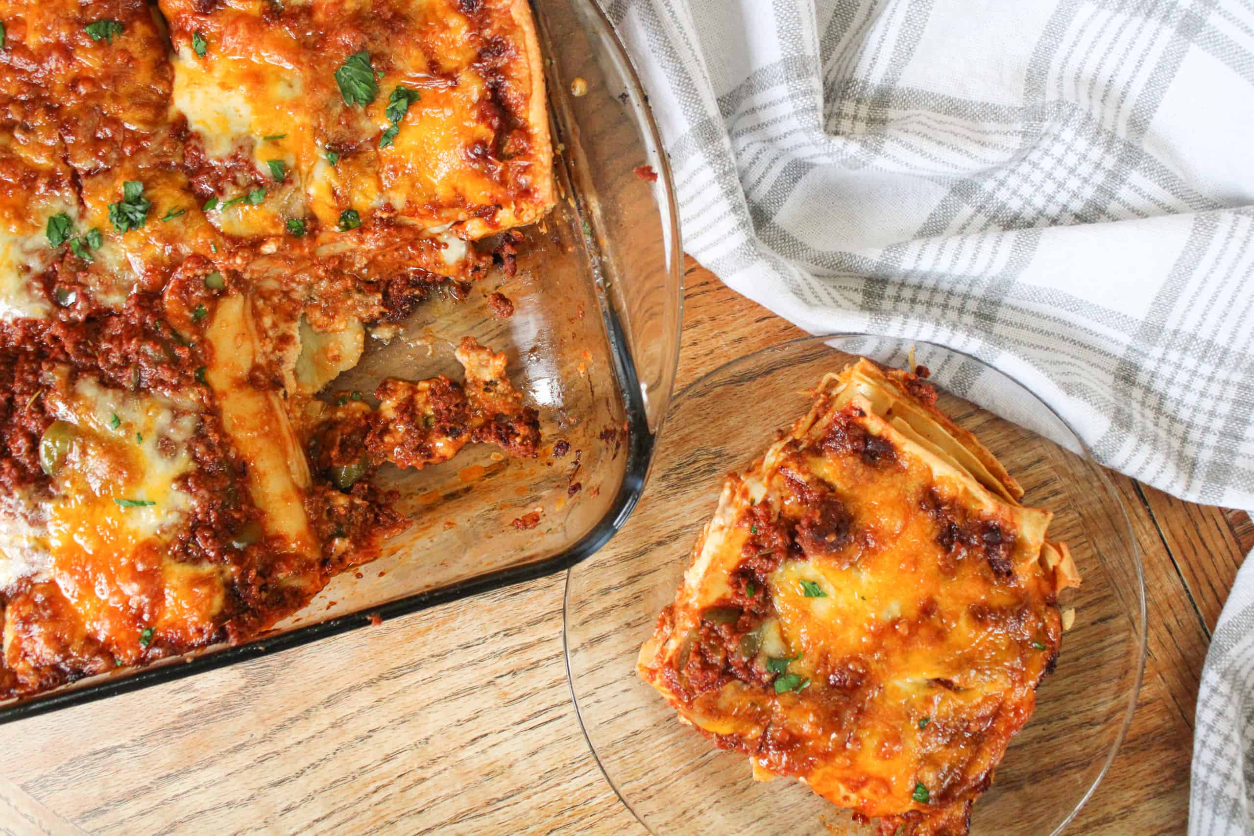 Baked homemade lasagna with homemade noodles on a plate.