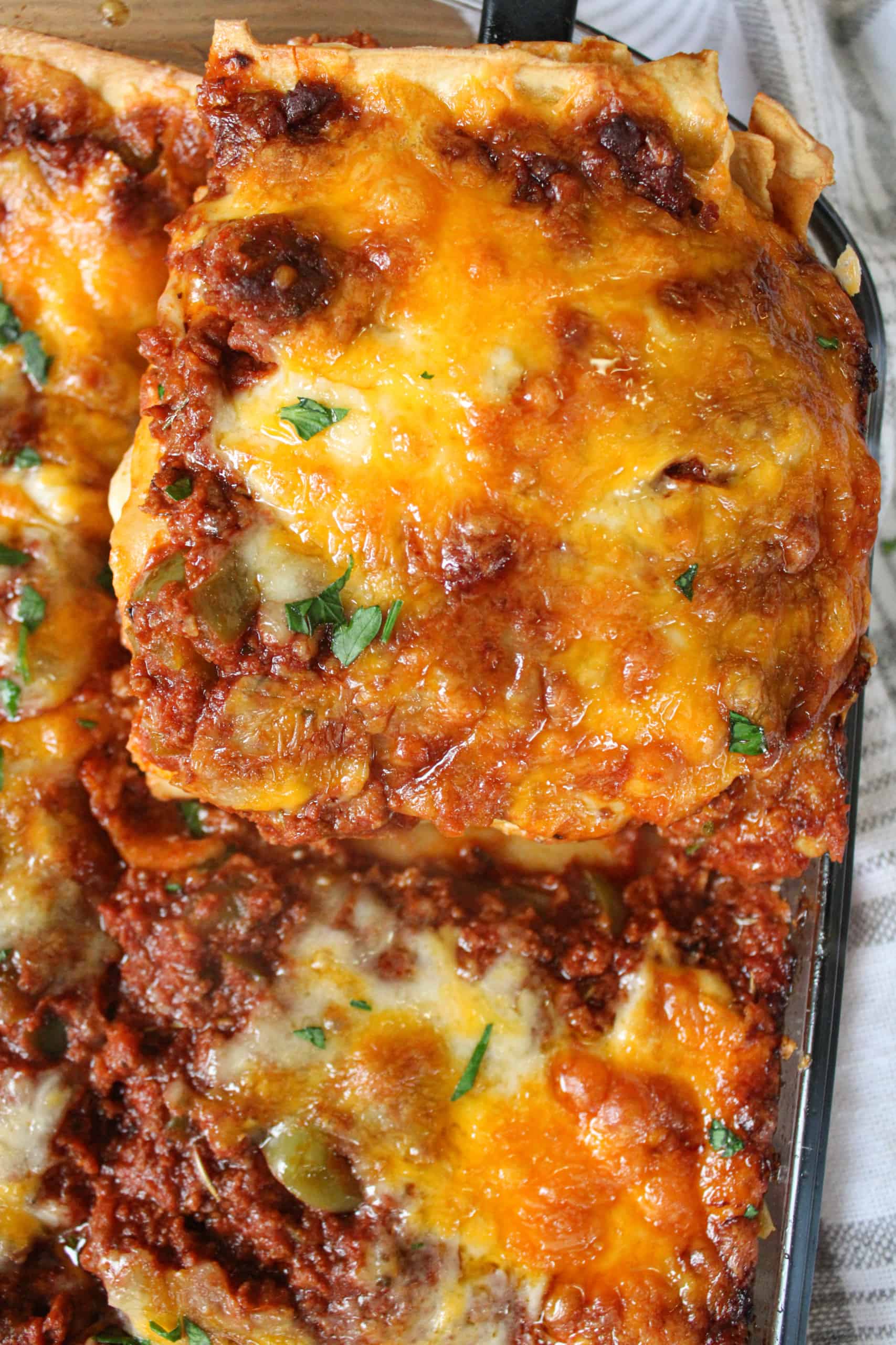 Close up on a slice of beef lasagna.