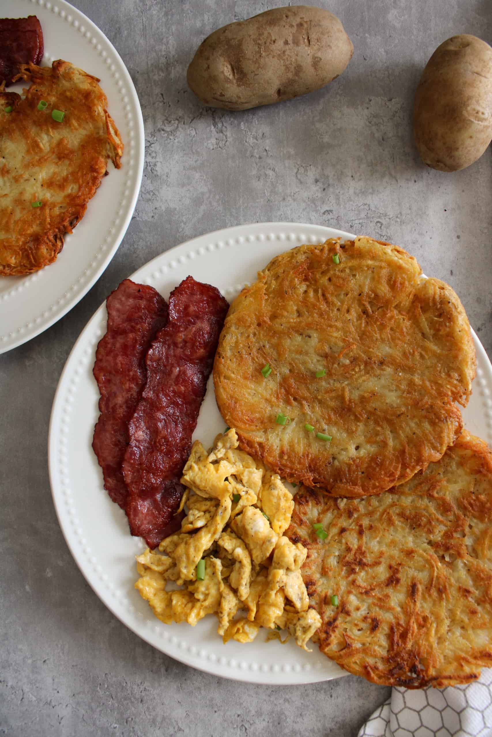 top view of breakfast potatoes with eggs and bacon