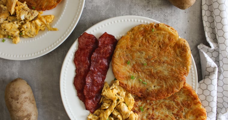 crispy hashbrowns on a plate with eggs and bacon