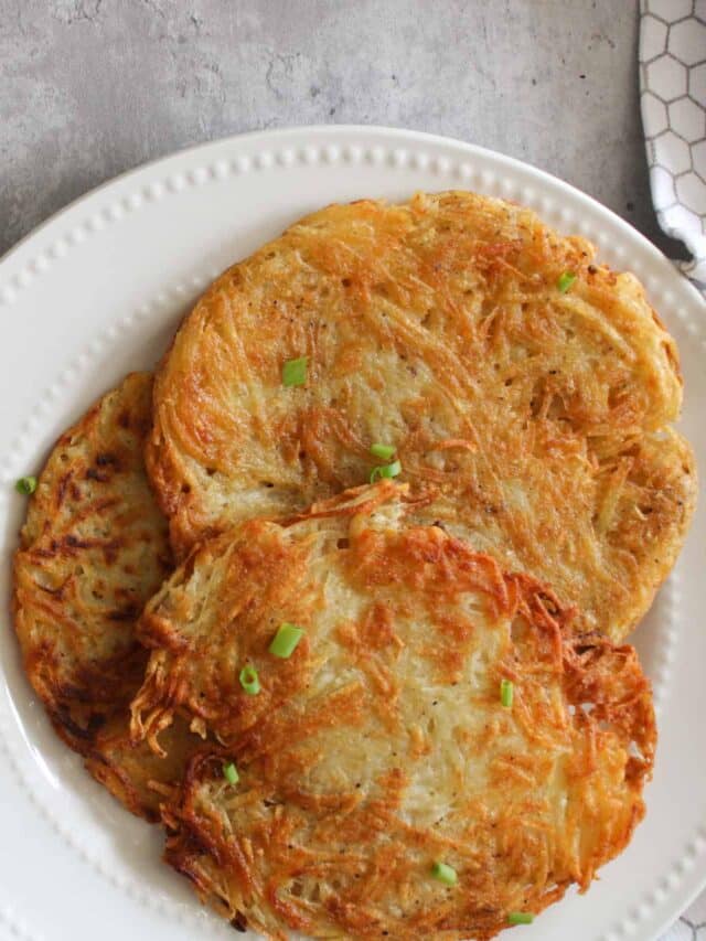 stack of hash browns and eggs on a plate