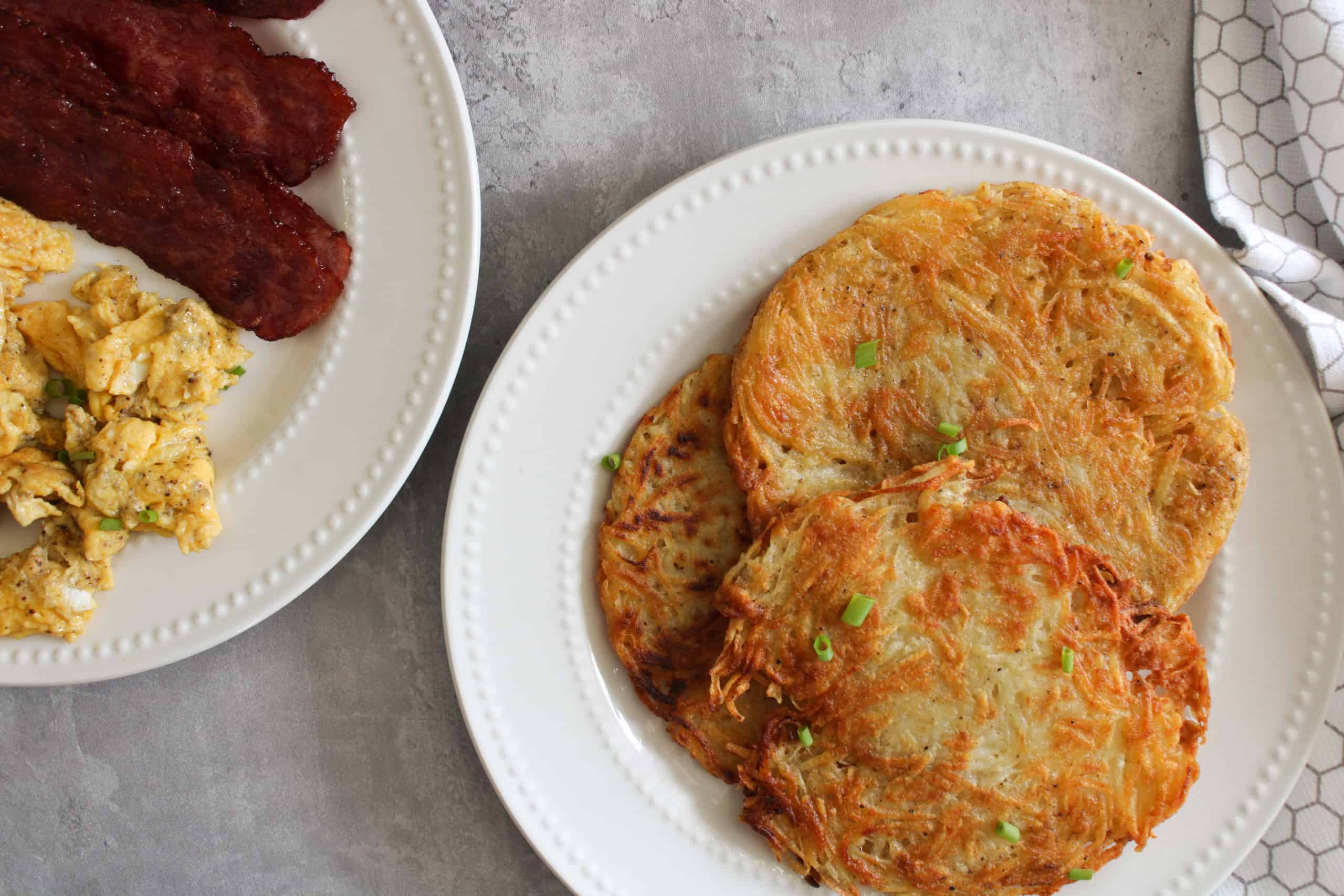 stack of hash browns and eggs on a plate