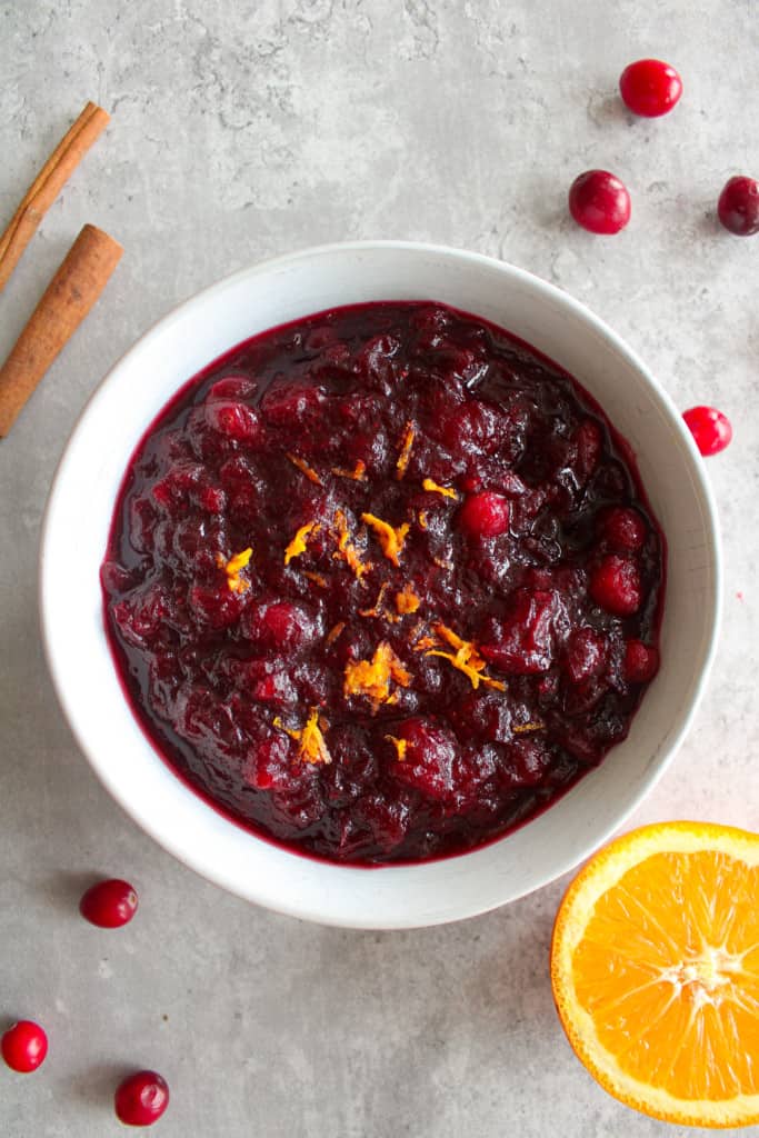 top view of cranberry sauce with orange in a bowl on a table