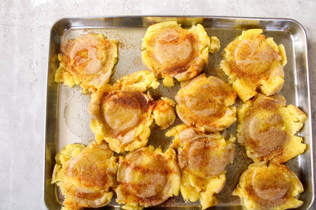 over head shot of smashed potatoes with seasonings