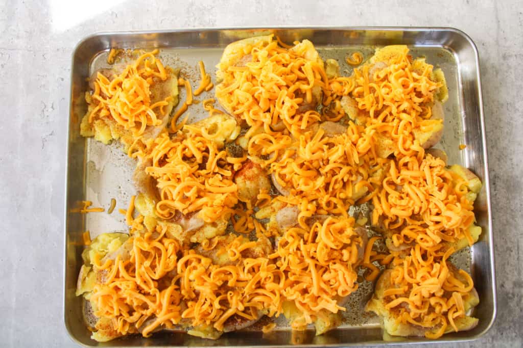 Crispy smashed potatoes with shredded cheese