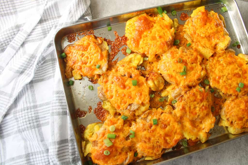 Over head image of easy baked smashed potatoes with cheddar cheese