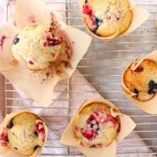 Close up on easy jumbo blueberry cranberry muffins on a wire rack.