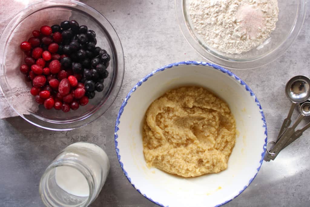 Ingredients for jumbo blueberry muffins in bowls on a table