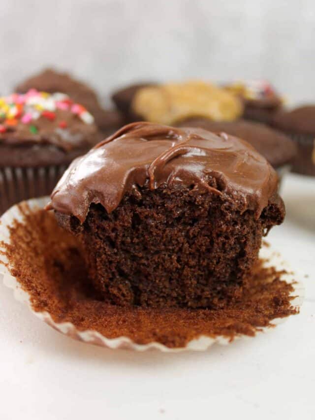 Close up on a bite shot of chocolate cupcake with frosting.
