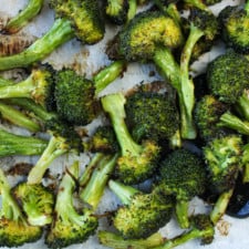 Close up of oven roasted broccoli in a sheet pan.