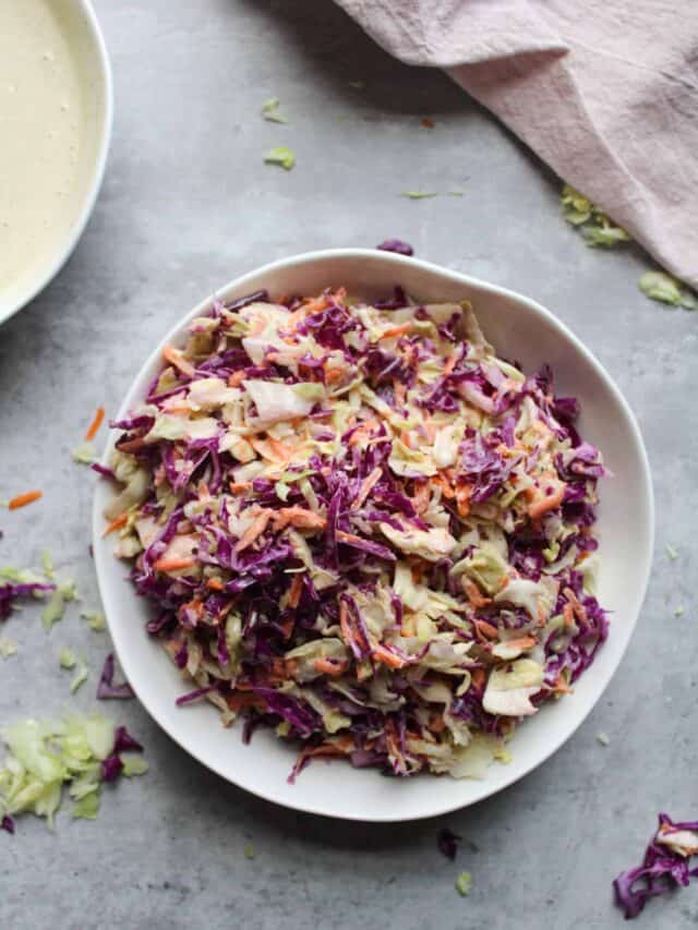 Easy purple coleslaw in a bowl on a table.