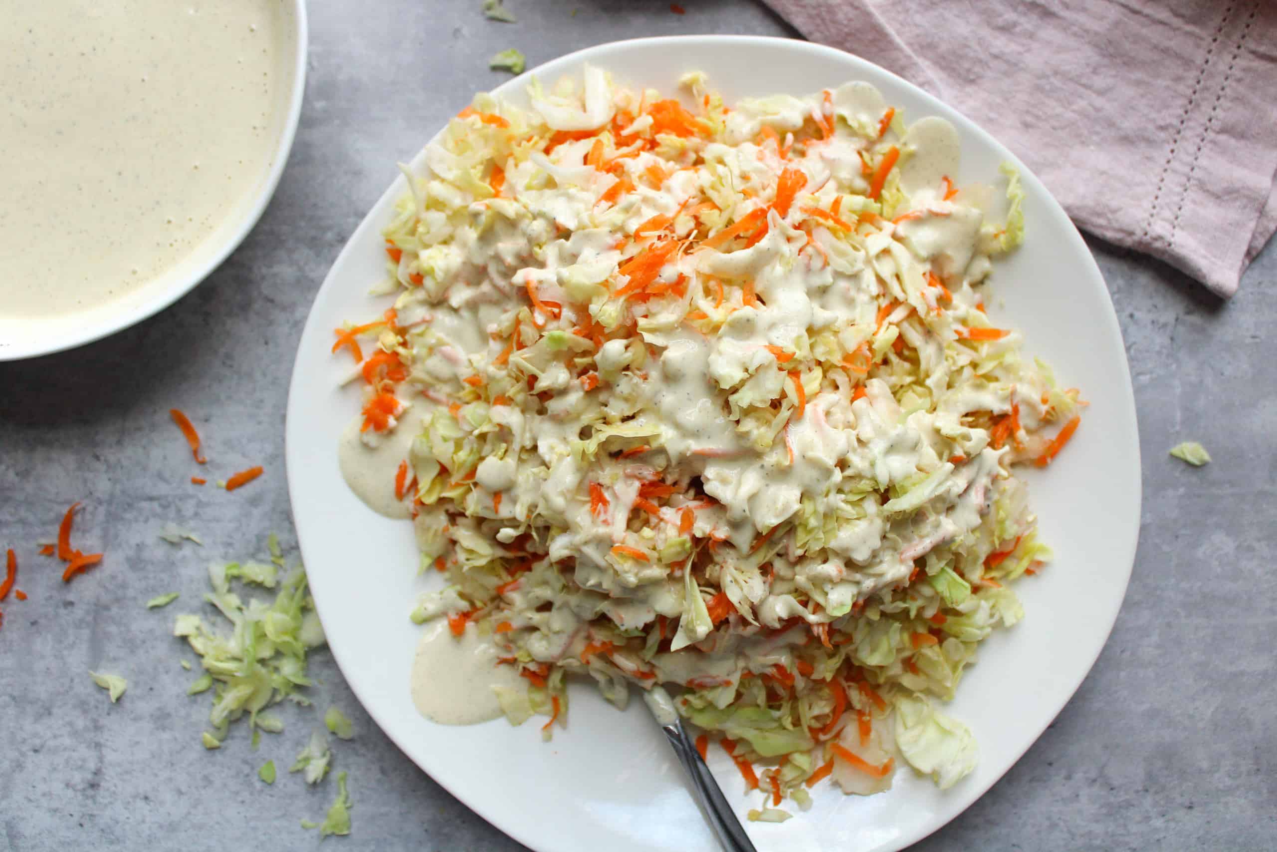 Easy coleslaw with dressing on a plate.