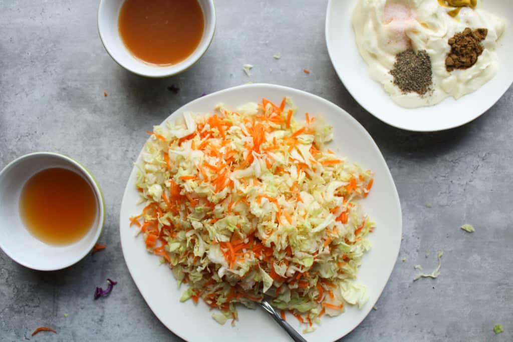 Healthy coleslaw recipe ingredients on a table. 