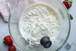 Close up on homemade whipped cream in mixing bowl.