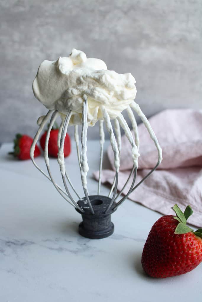 Whisk with whipped cream on top. 