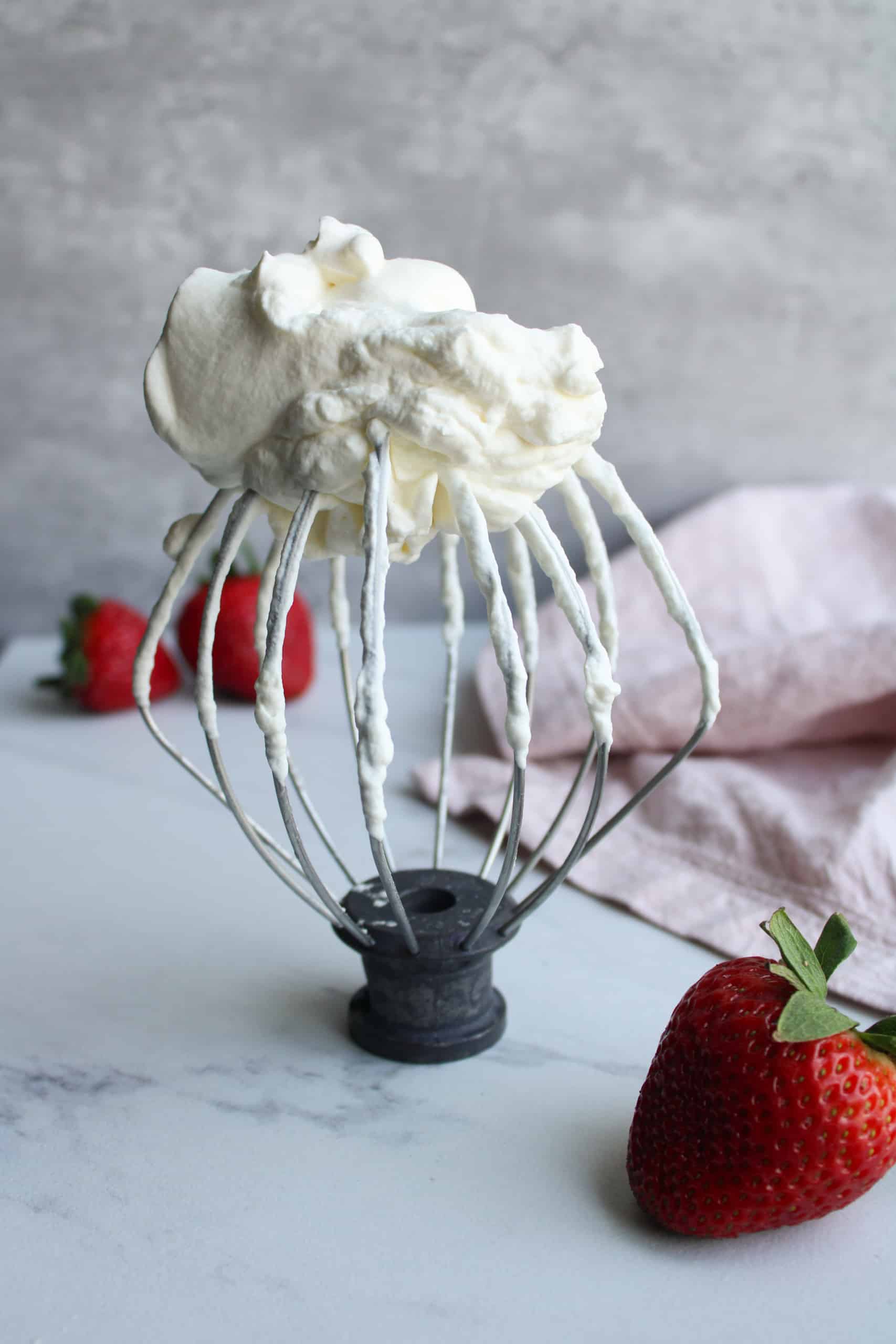 Whisk with whipped cream on top.