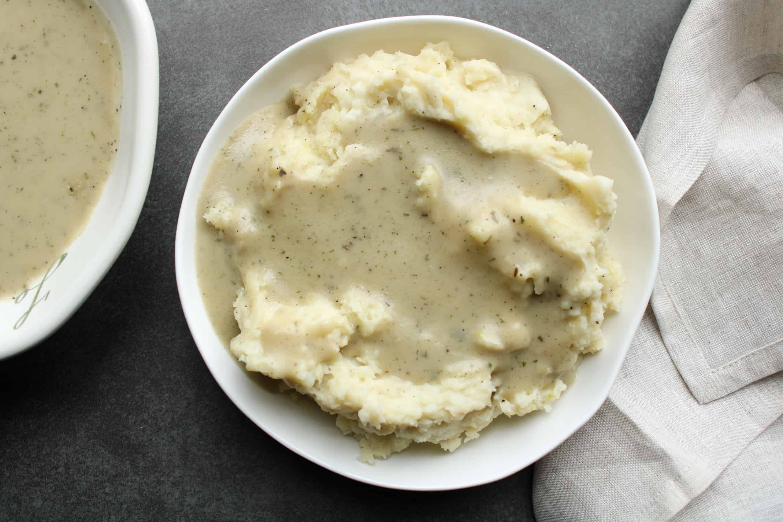 Overhead image of homemade gravy over mashed potatoes.