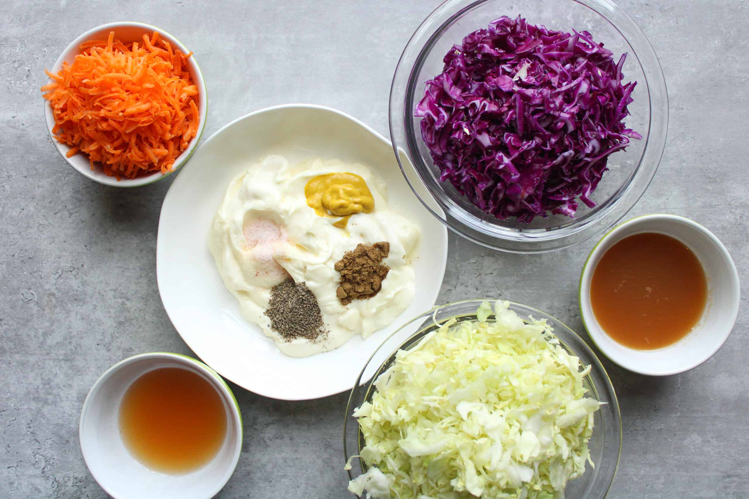 Traditional coleslaw recipe ingredients on a table.