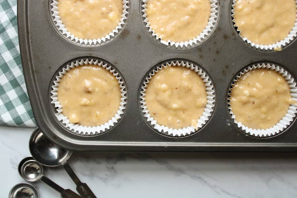 Banana muffin batter in muffin pan. 