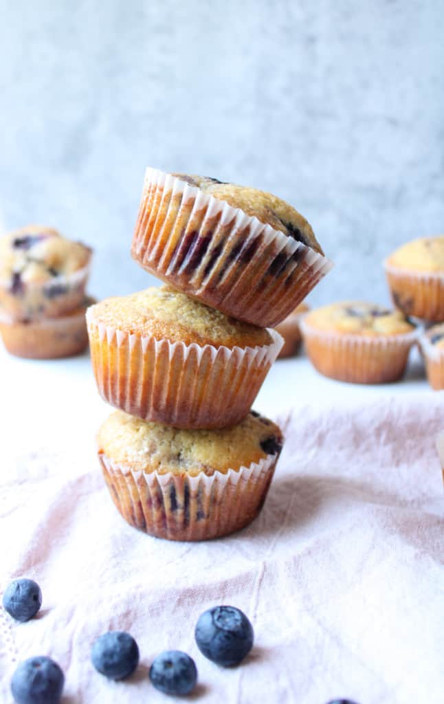 Close up on stacked blueberry muffins.