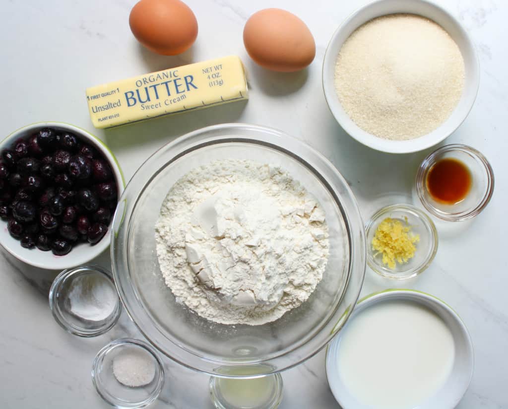 Ingredients for lemon blueberry muffins on a table. 