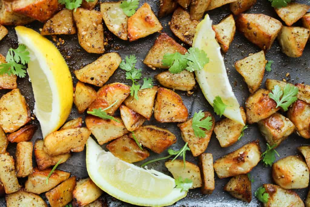 Zaatar potatoes with lemon wedges. 