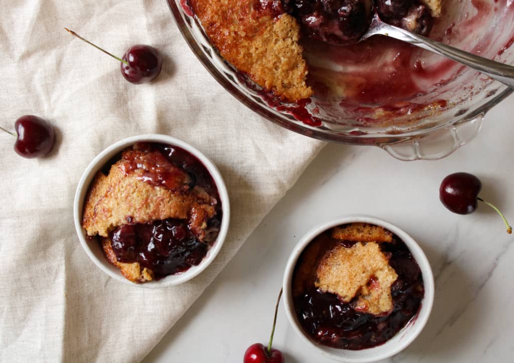 Overhead of cherry cobbler in small bowls.