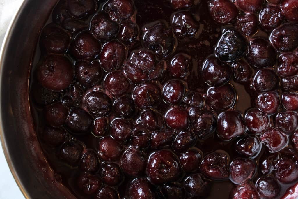 Close up on cherry cobbler filling.