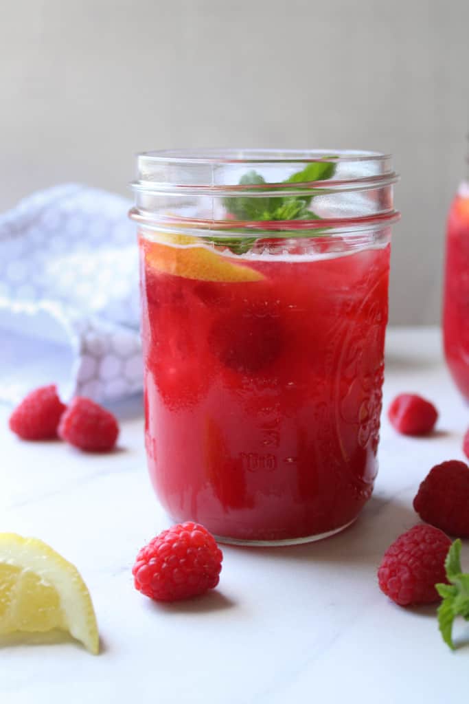 Close up on homemade raspberry lemonade in a glass. 