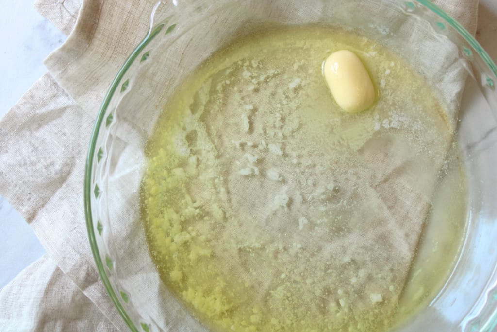 Melted butter in a pie dish.