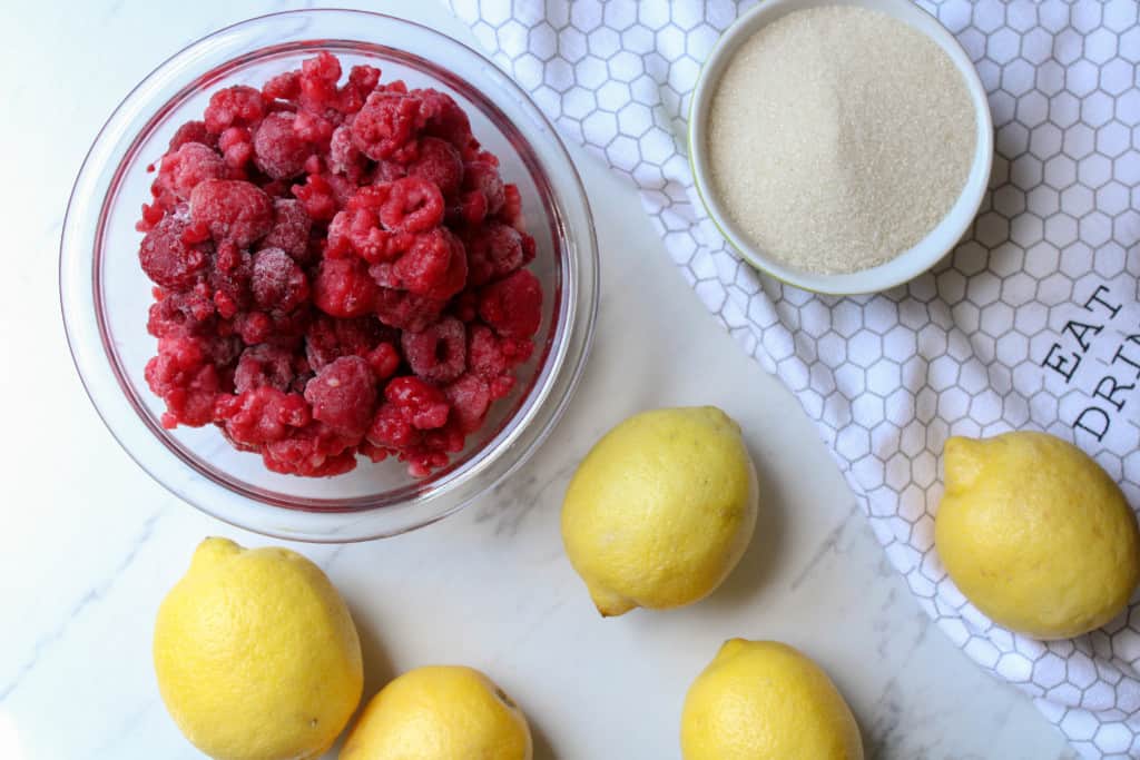 Raspberry lemonade ingredients on a table. 