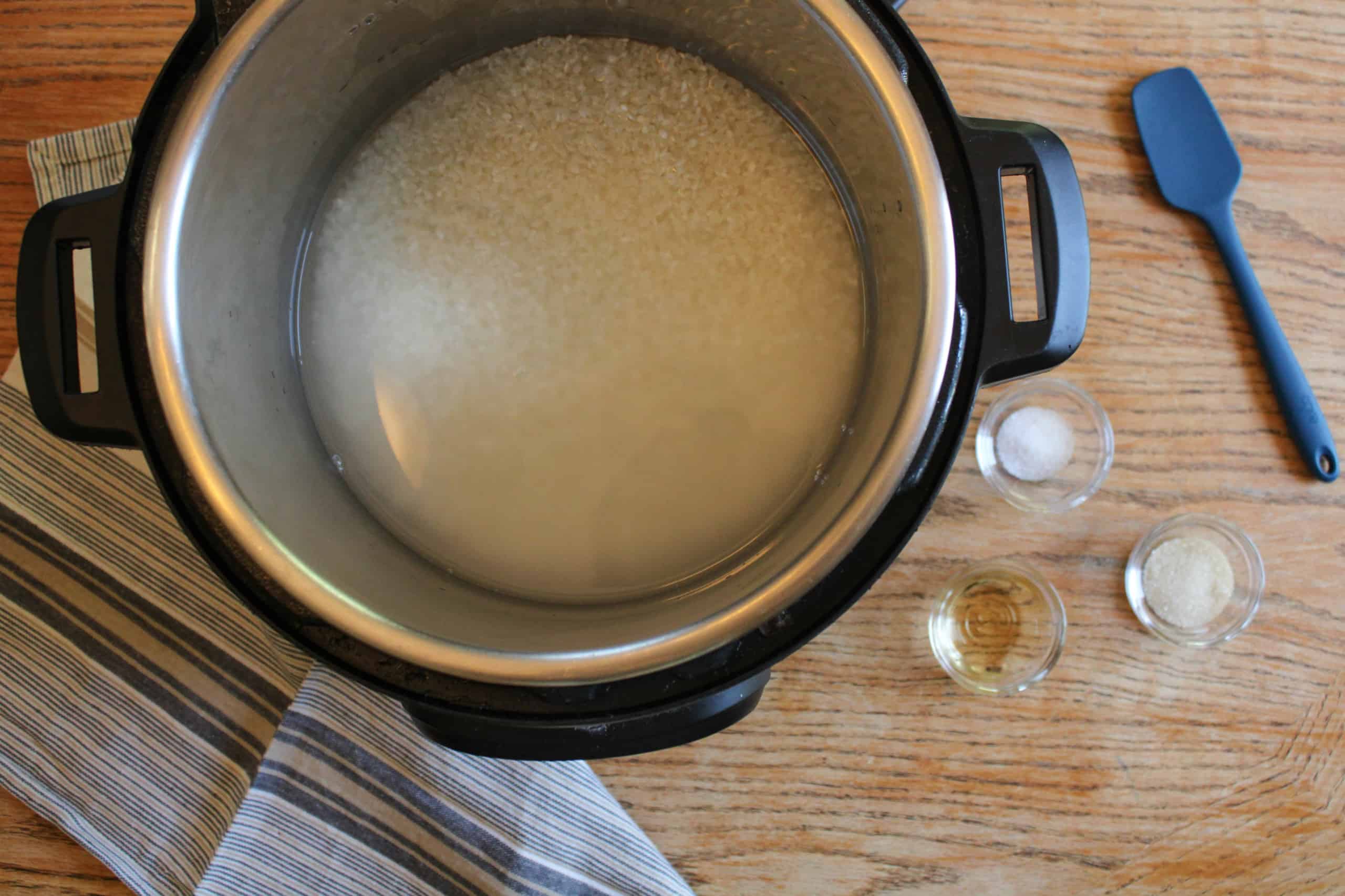 Rice and water in the inner bowl of an instant pot.
