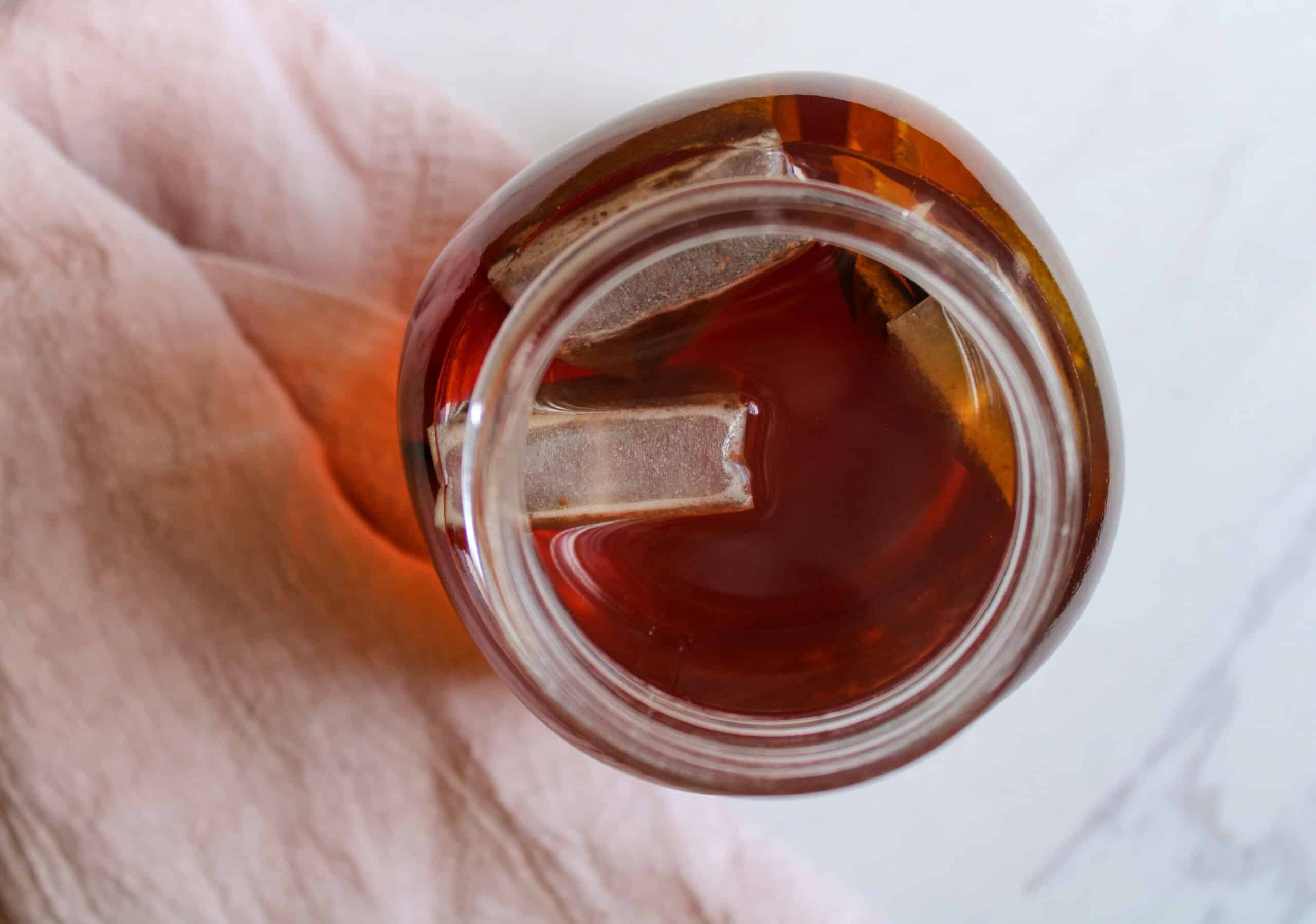 Overhead view of tea in a mason jar with a tea bag.