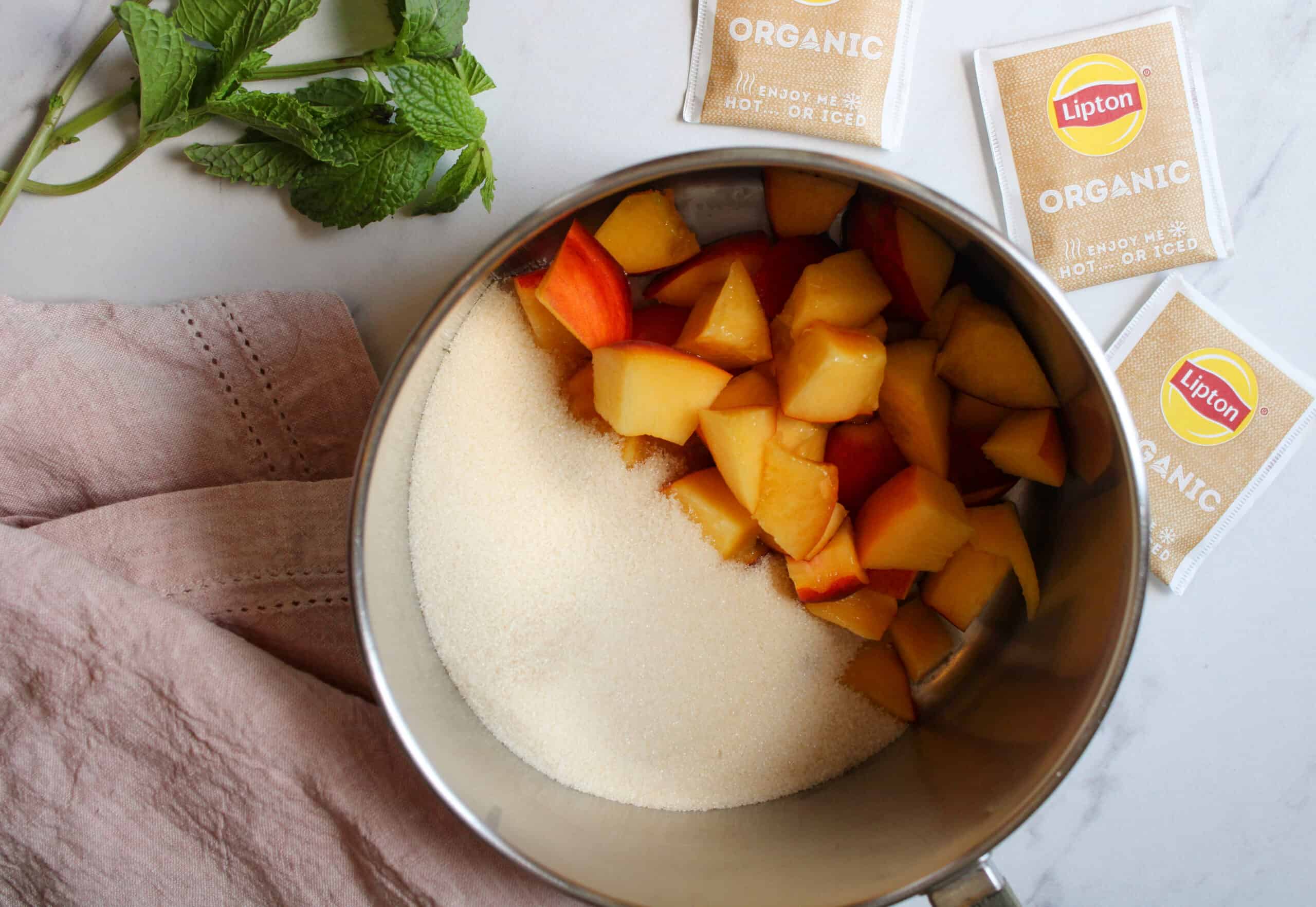 Peach sweet tea ingredients in a pot.